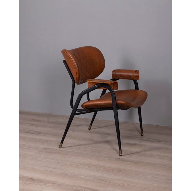 Armchair with black metal frame and brown faux leather upholstery, curved wooden armrests, designed by Gastone Rinaldi for...