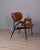 Armchair with black metal frame and brown faux leather upholstery, curved wooden armrests, designed by Gastone Rinaldi for...
