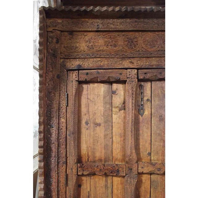 Intricate and beautifully done pair of teak double doors in a substantial hand carved frame. Elaborate floral and foliate...