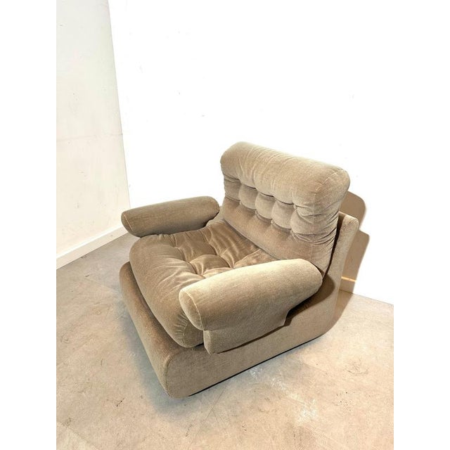 Comfortable vintage lounge chair featuring generous proportions and deep, soft cushioning. This armchair is upholstered in...