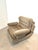 Comfortable vintage lounge chair featuring generous proportions and deep, soft cushioning. This armchair is upholstered in...