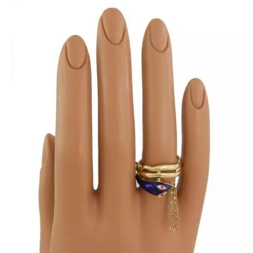 This is a unique style ring, it is crafted from 18k yellow gold featuring a snake head with blue enamel and ruby eyes,...