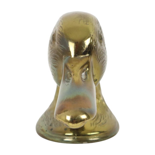 Iconic vintage bottle opener shaped like a duck's head, marked "Ducky Paris" on the bottom; a mid-20th-century collectible...