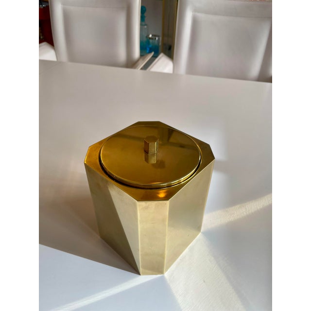 Octagonal ice bucket with mouth-blown glass insert made of solid brass.