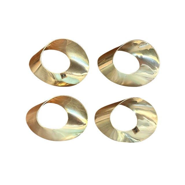 A lovely set of vintage brass napkin rings. Each features a sculptural, elliptical brass form. Cast in brass. Unmarked....