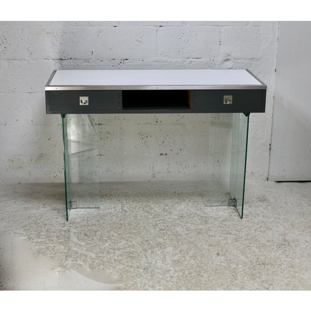 Modernist console table, 1960s, glass base, wood and white melamine top. Light scratches and small dents visible on the...