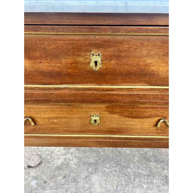Elegant 19th-century French Louis XVI commode crafted in walnut with a white marble top. Featuring two spacious drawers,...