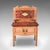 This is an antique washstand. An English, pine and faux marble gallery back dressing table, dating to the Edwardian...