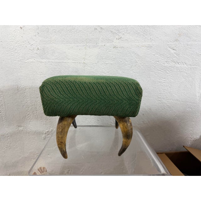 This is a highly unusual footstool crafted from natural animal horn. The piece features four curved horn supports joined...