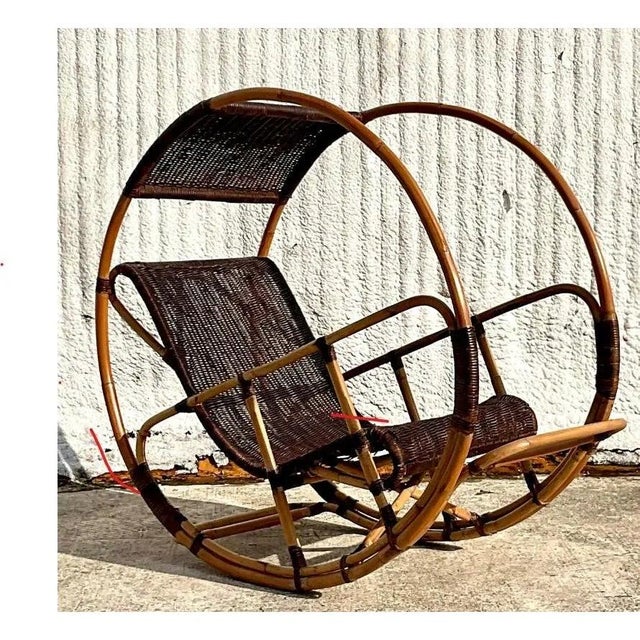 A fantastic vintage Coastal Italian wrapped rattan rocking chair. After the “Donaoldo” chair designed my Franco Bettonica....