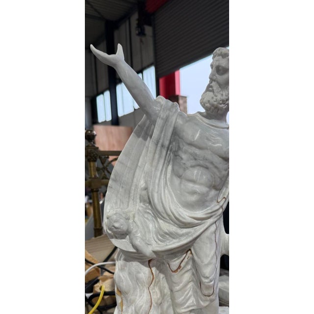 A majestic 20th-century solid marble Roman statue, exquisitely carved to capture the grandeur and elegance of classical...