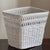 A beautiful and well preserved Boho-style white wicker wastebasket from the mid-20th century. This gorgeous handwoven...