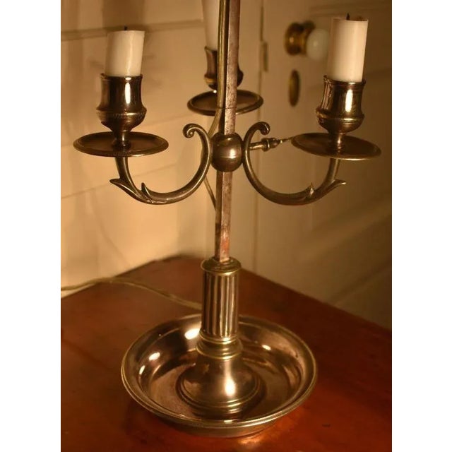 French Bouillotte lamp, 19th century. Cast in heavy bronze with somewhat worn silver plating the lamp carries an...