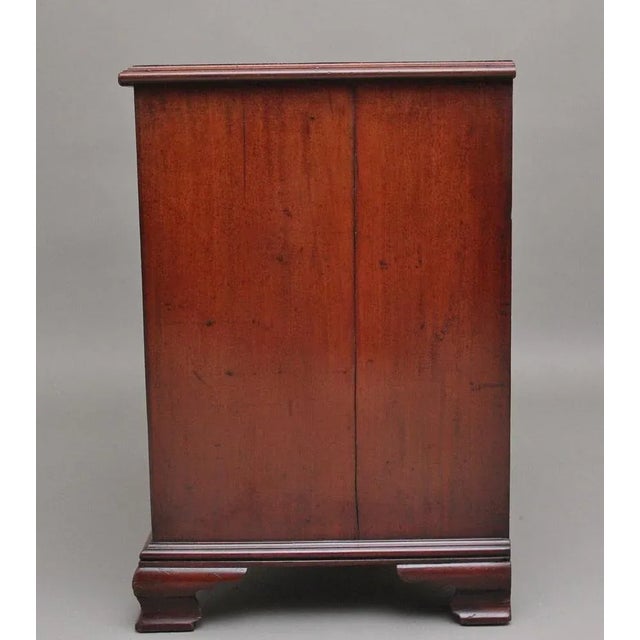 18th Century mahogany kneehole desk, having a wonderfully figured moulded edge top above a selection of seven drawers with...
