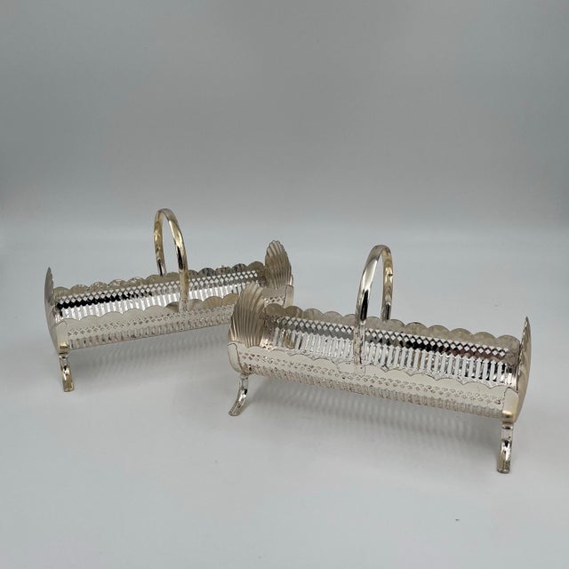 These beautifully detailed mid-century silverplate cracker server baskets, also known as biscuit troughs, were made in...