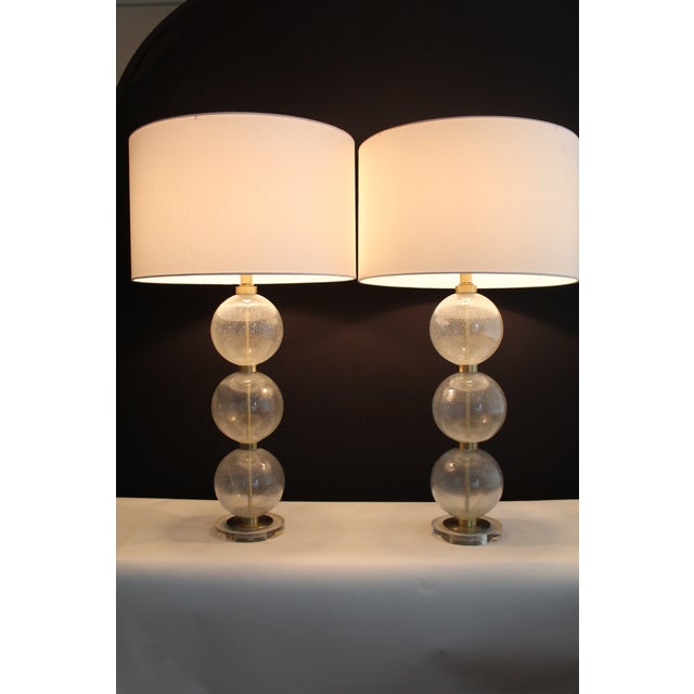 Pair of Seguso influence. Stacked Murano spheres. .Hand blown bubble glass. Mounted on crystal and satin brass bases. The...