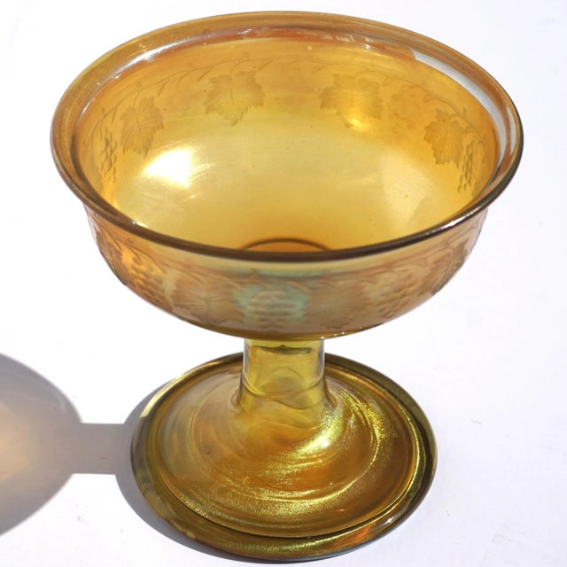 A wonderful L.C.T. gold Favrile champagne or sorbet glass cup with engraved grape clusters and wine leaves. Engraved...
