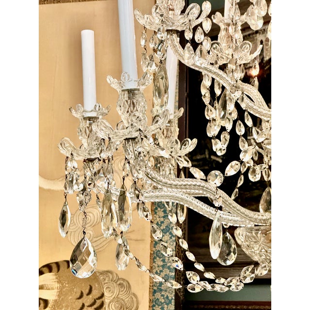 This is a large mid-20th century 12-Light Bohemian Crystal Chandelier. The photos speak to the beauty of this chandelier....