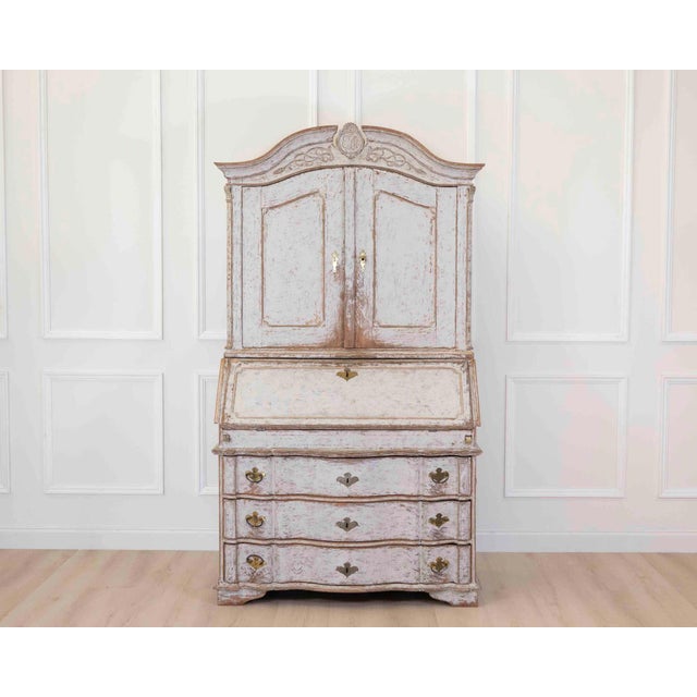 An exceptional 18th century Danish Rococo secretary dating to circa 1760 and featuring an elegant serpentine front with...
