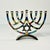 A gorgeous postmodern Menorah from the 1980s. It’s a chrome finished metal with gorgeous enamel painted mosaic style nine...