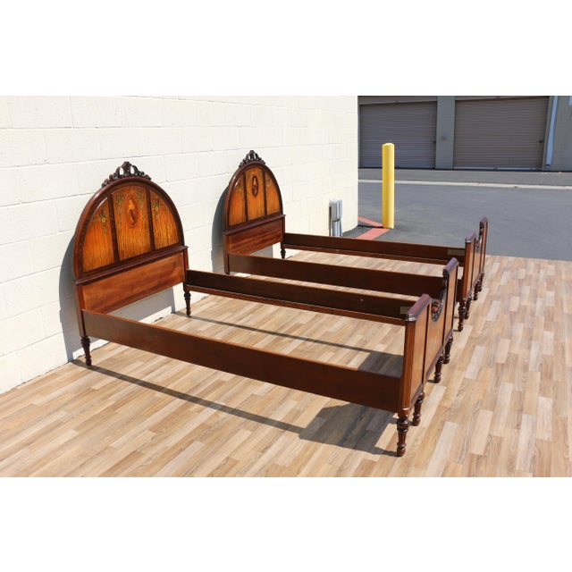 An elegant pair of early 20th-century Louis XV style twin bed frames, beautifully crafted from solid wood and adorned with...
