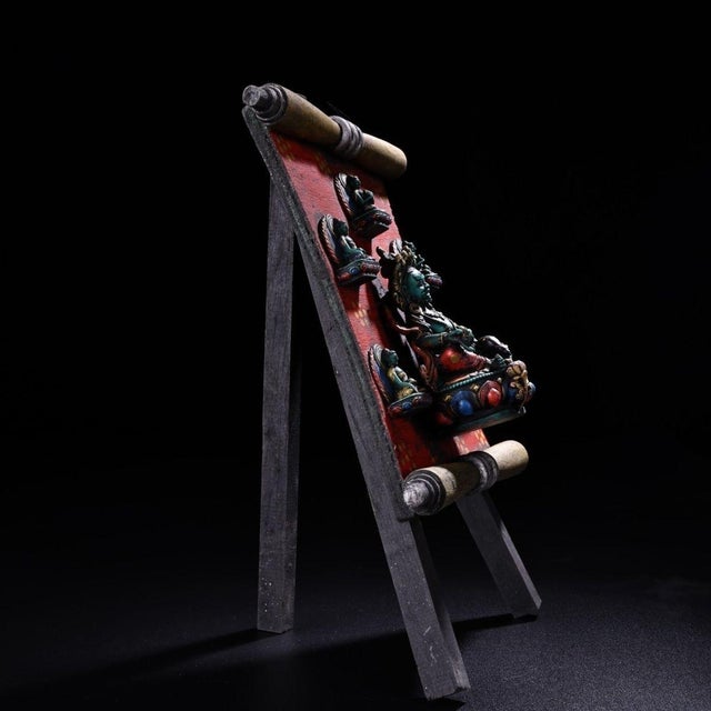 This is a rare and exquisite vintage Tibetan Tsa Tsa shrine, featuring hand-painted clay reliefs mounted on an aged red...