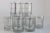 Fabulous set of eight new old stock Georges Briard glasses with wraparound silver tone grid. Like all decorated barware,...