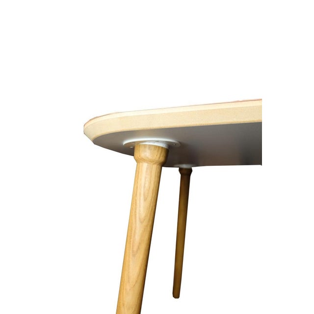 Dining table, designed by Karsten Lauritsen with solid oak legs with a laminate surface in the color salsa linoleum. The...