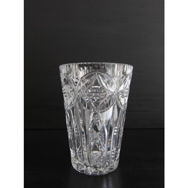 A beautiful handmade crystal glass vase. Circa 1960s. The traditional craft of glassblowing and glass cutting turns...