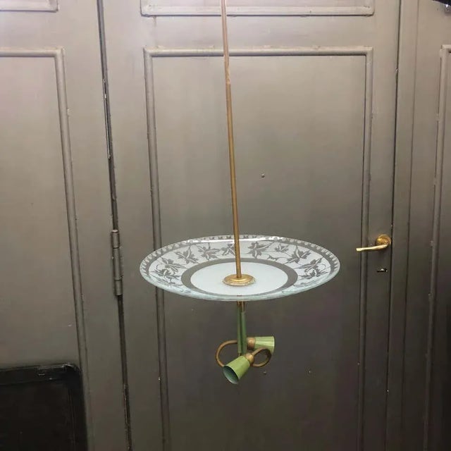 A pendant by Stilnovo, brass and glass are in good conditions, it works 110-240 volts and needs regular bulbs. It's...