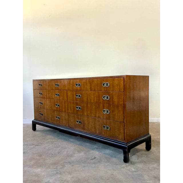 This exceptionally long Mid-Century Modern dresser embodies the sophisticated blending of sleek American design with...