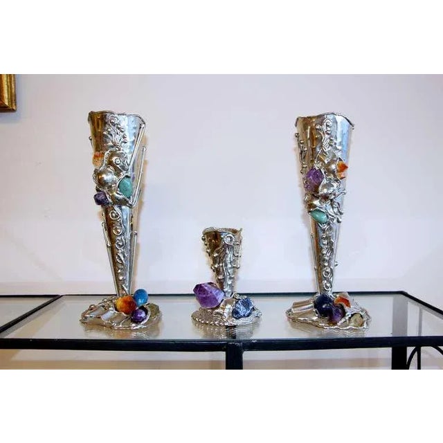 A nice group of three vases, two taller vases and a shorter one, which is 5.5 inches tall and 4 inches in diameter. The...