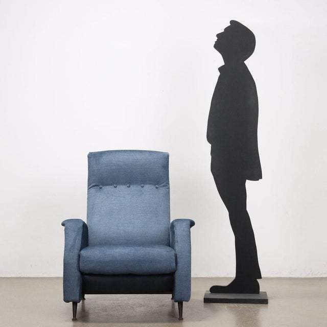 Reclining armchair covered in aviation fabric with foam padding, metal and wood structure. This piece is attributed to the...