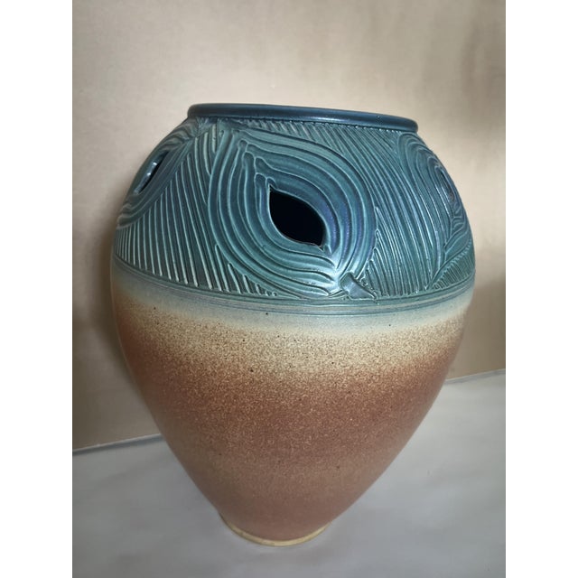 A large ovoid stoneware vase by American studio potter Mark Untener, c. 1990s–2000s. The shoulder carries a deeply carved...