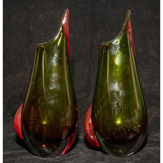 Pair of mid-century Murano vases in deep green glass, each wrapped with an applied red serpentine band, executed in the...