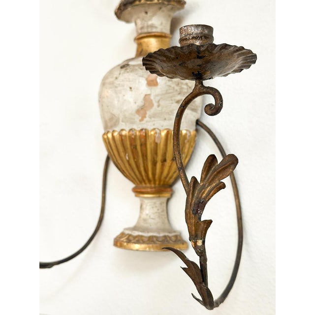 A whimsical and romantic pair of Italian urn-form wall sconces, crafted with elegant scrollwork and classical detailing....