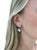 These elegant earrings are comprised of four kite shaped diamonds suspending four pear shaped diamond drops for a total...