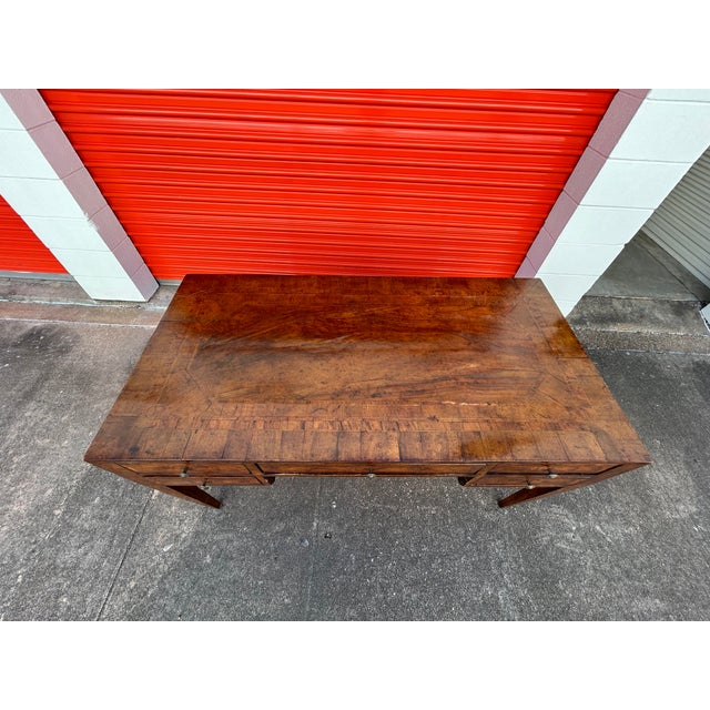 Italian Louis XVI Style Desk. This handsome Italian desk or writing table has 2 side drawers and 1 center drawer and...