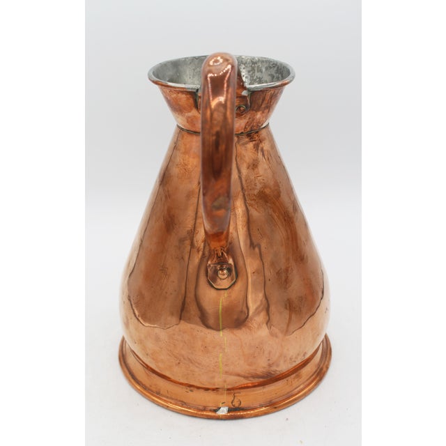 Circa 1860 copper 1/2 gallon measure, English. Tinned interior & c-scroll handle. Nice warm color. Some dings commensurate...