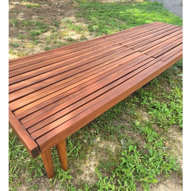 Beautiful and versatile expandable mid century minimalist walnut slat bench designed by John Keal for Brown Saltman, circa...