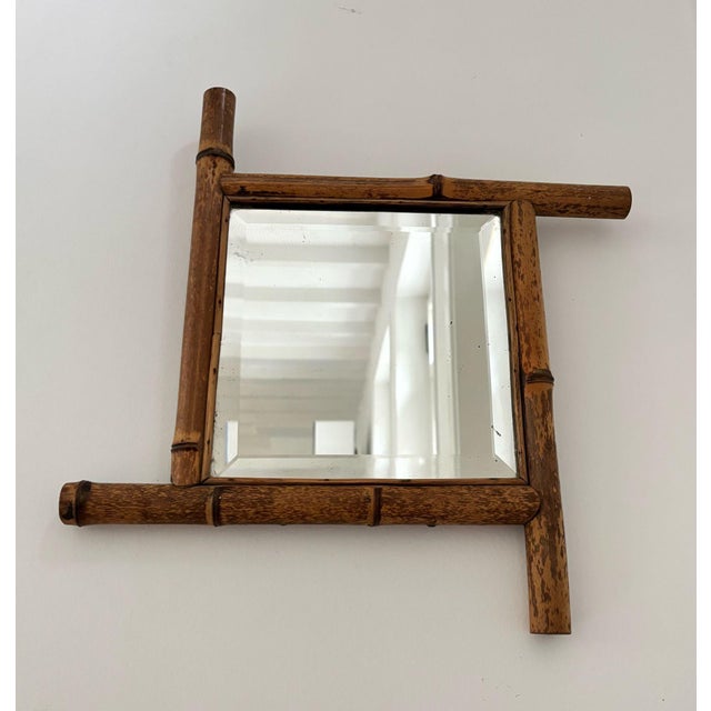 Beautiful antique wall mirror, with a nicely shaped real bamboo frame. Nice facet cut mirror glass which shows some age...