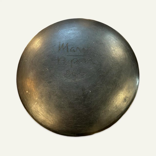 This Avanyu or Water Serpent design plate in black on black pottery by Maria Martinez and Popovi Da from the San Ildefonso...