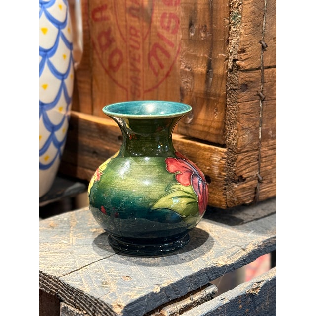 A beautiful vintage Moorcroft Pottery Hibiscus vase, decorated with large hand-painted hibiscus blooms in shades of...