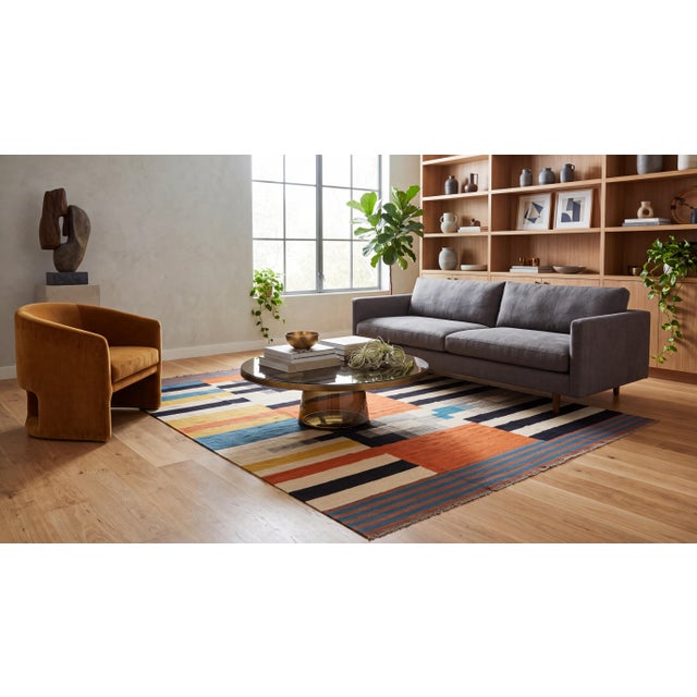 An exceptional showcase of textile artistry, this modern hand-woven wool Kilim rug features a striking color-blocked...