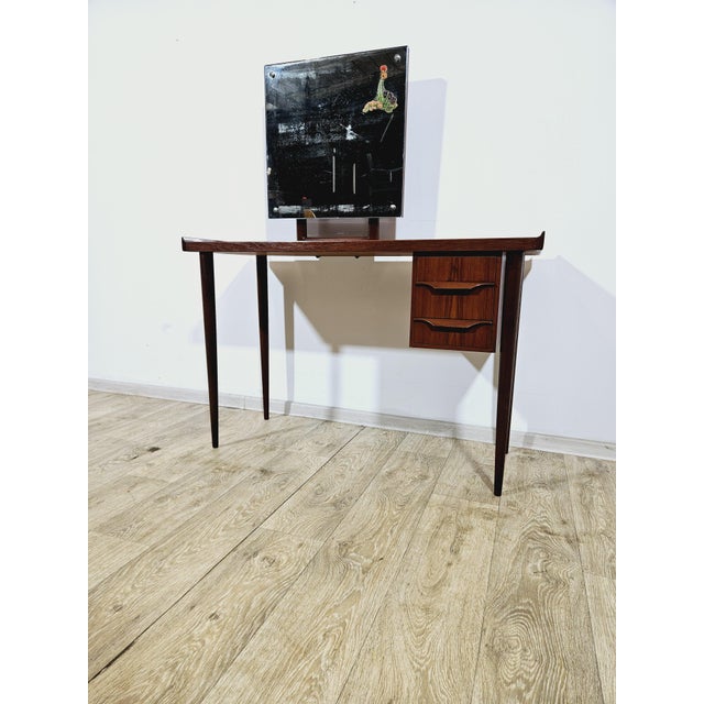 An elegant, small teak dressing table, designed by Gunnar Nielsen Tibergaard, manufactured in Denmark in the 1960s. It...