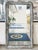 Hand-crafted in the 19th Century in France, this antique vertical wall mirror has a silver gilt frame with an ogee bevel....