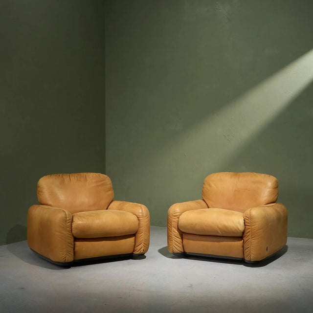 The Piumotto Cognac Leather Lounge Chairs, designed by Arrigo Arrighi for Busnelli in the 1970s, are a stunning example of...