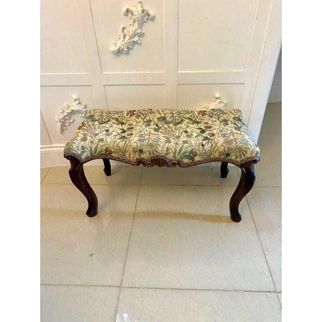 A charming Victorian carved walnut window seat of elegant proportions and attractive design. The serpentine shaped seat...