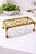 Vintage solid brass trivet stand with intricate pierced scrollwork and a raised footed silhouette, offering both function...