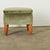 Dimensions: 18 ¼” H x 20 ½” W x 19 ¾” D A pretty and plush footstool from the Art Deco period with elegant hand-carved...